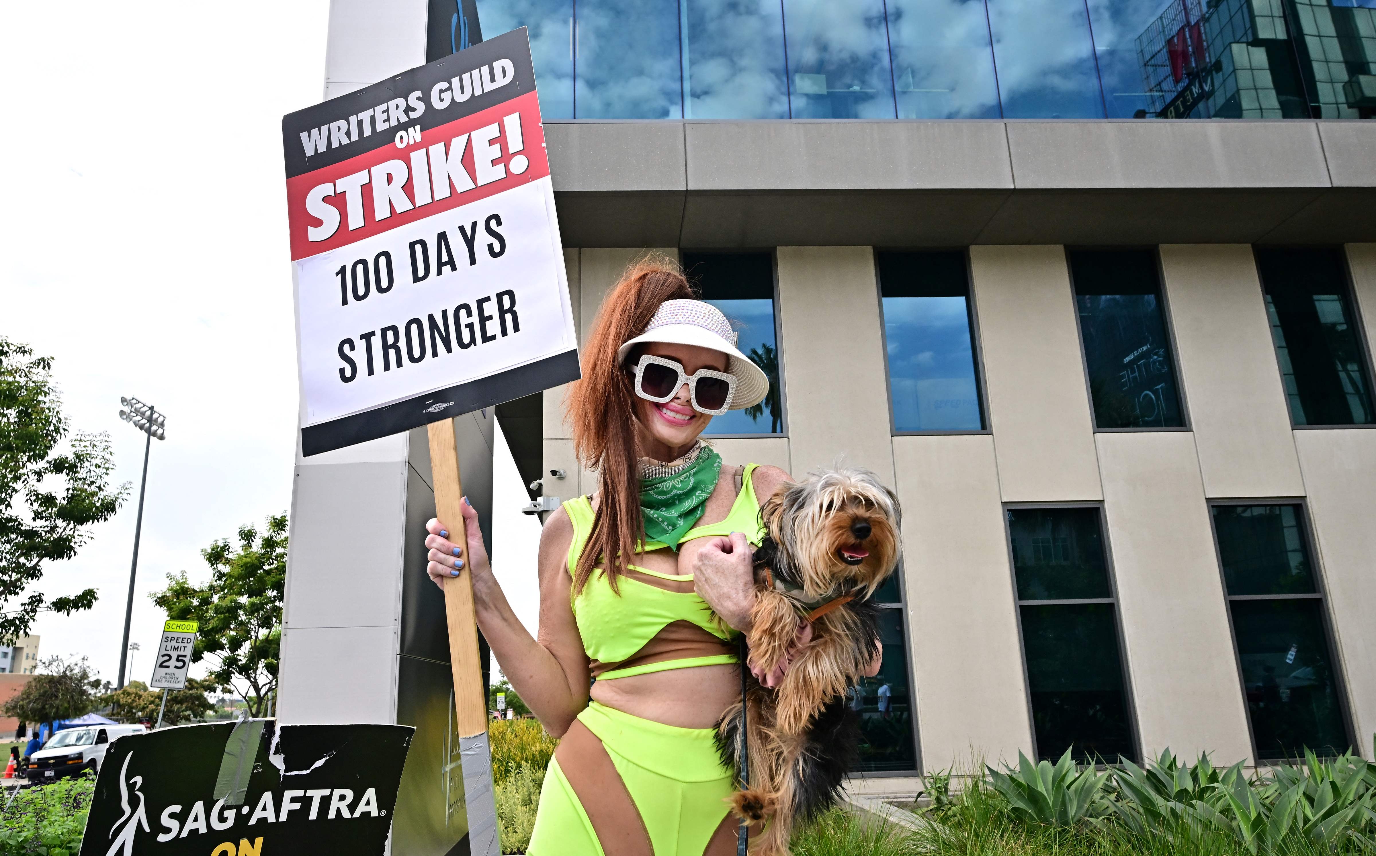 Phoebe Price, the actress, and her dog join a picket of Netflix in Hollywood as part of the strike by screenwriters and actors