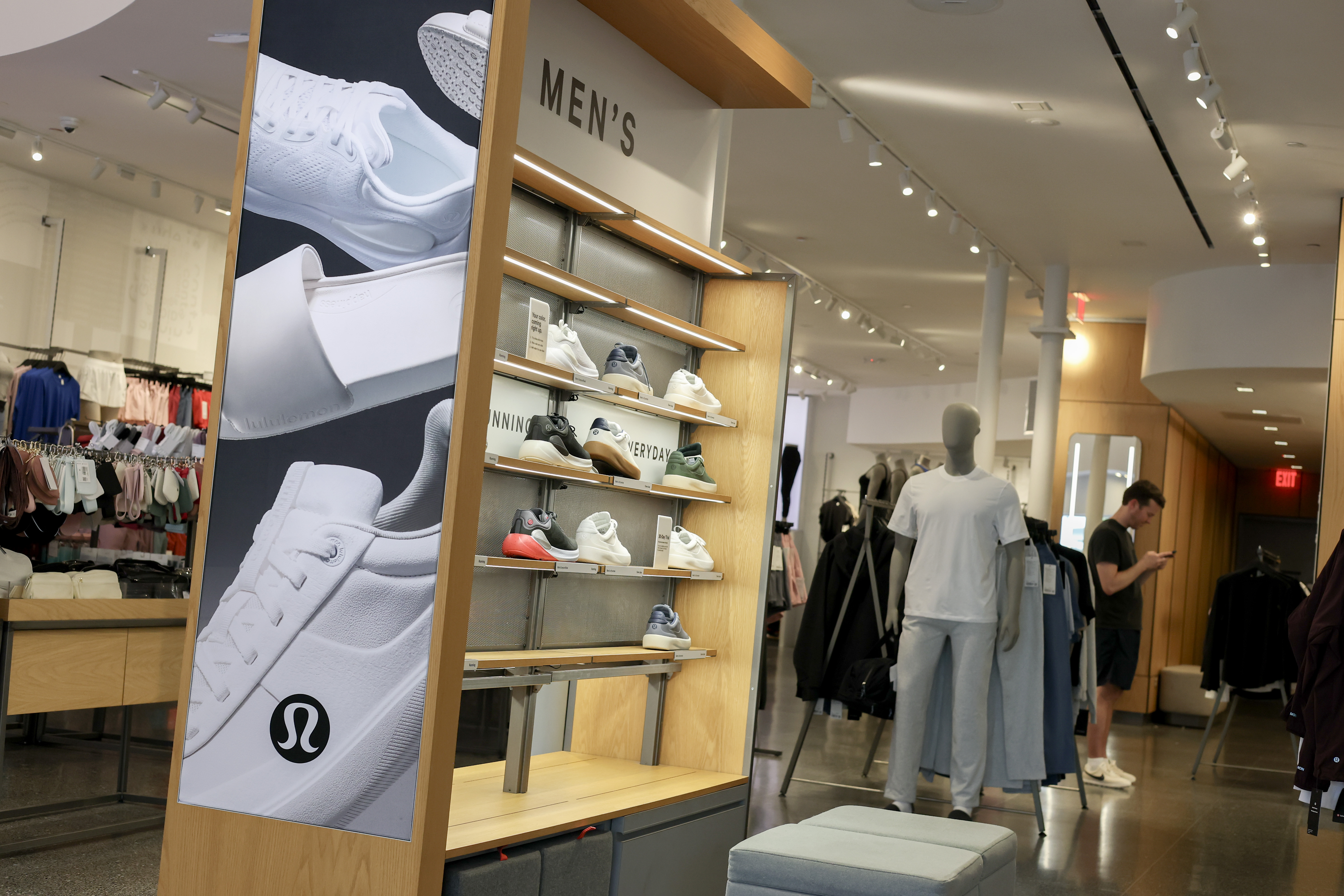 Lululemon men's shoes on display in a store.
