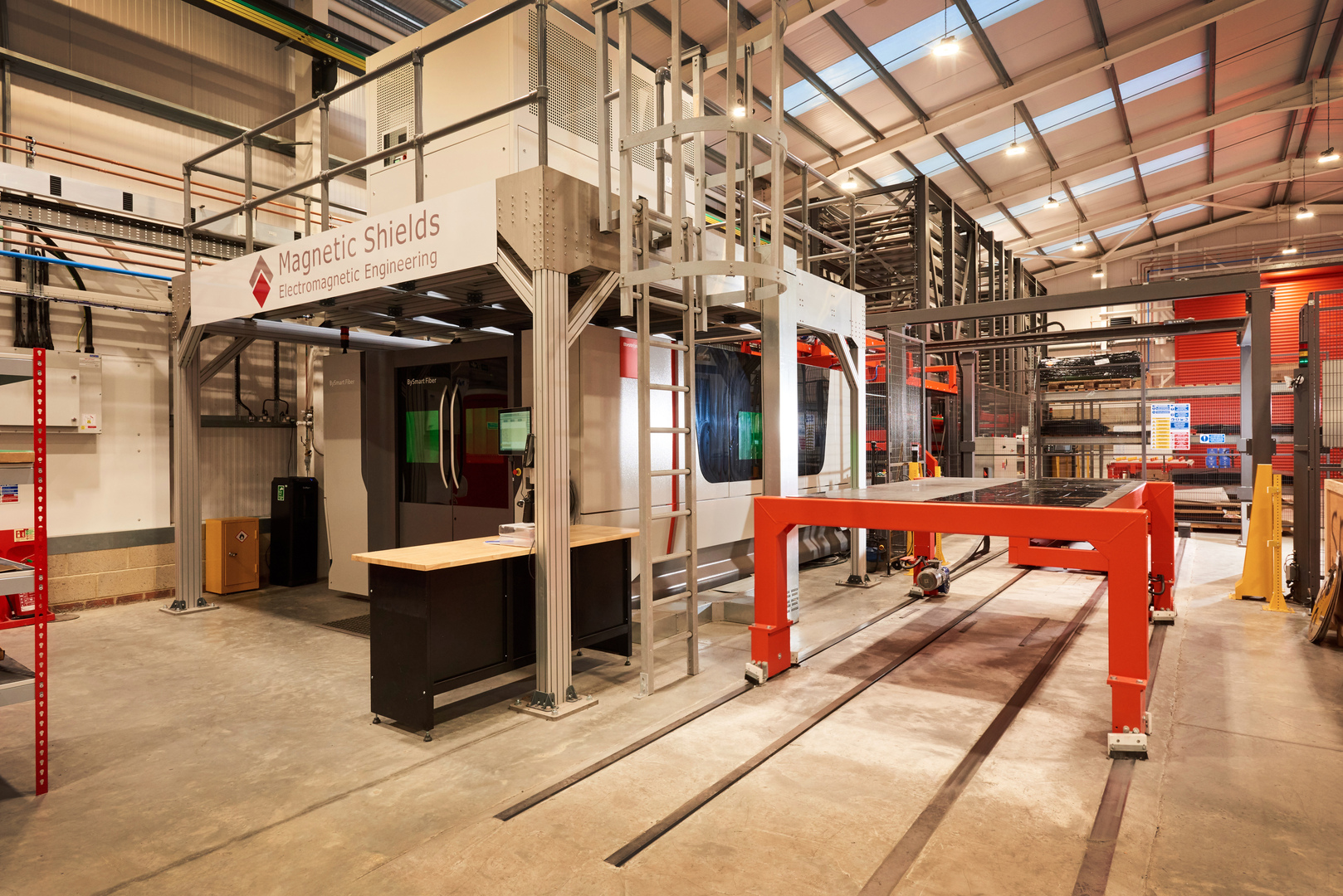 Magnetic Shields factory interior featuring laser cutting machinery.