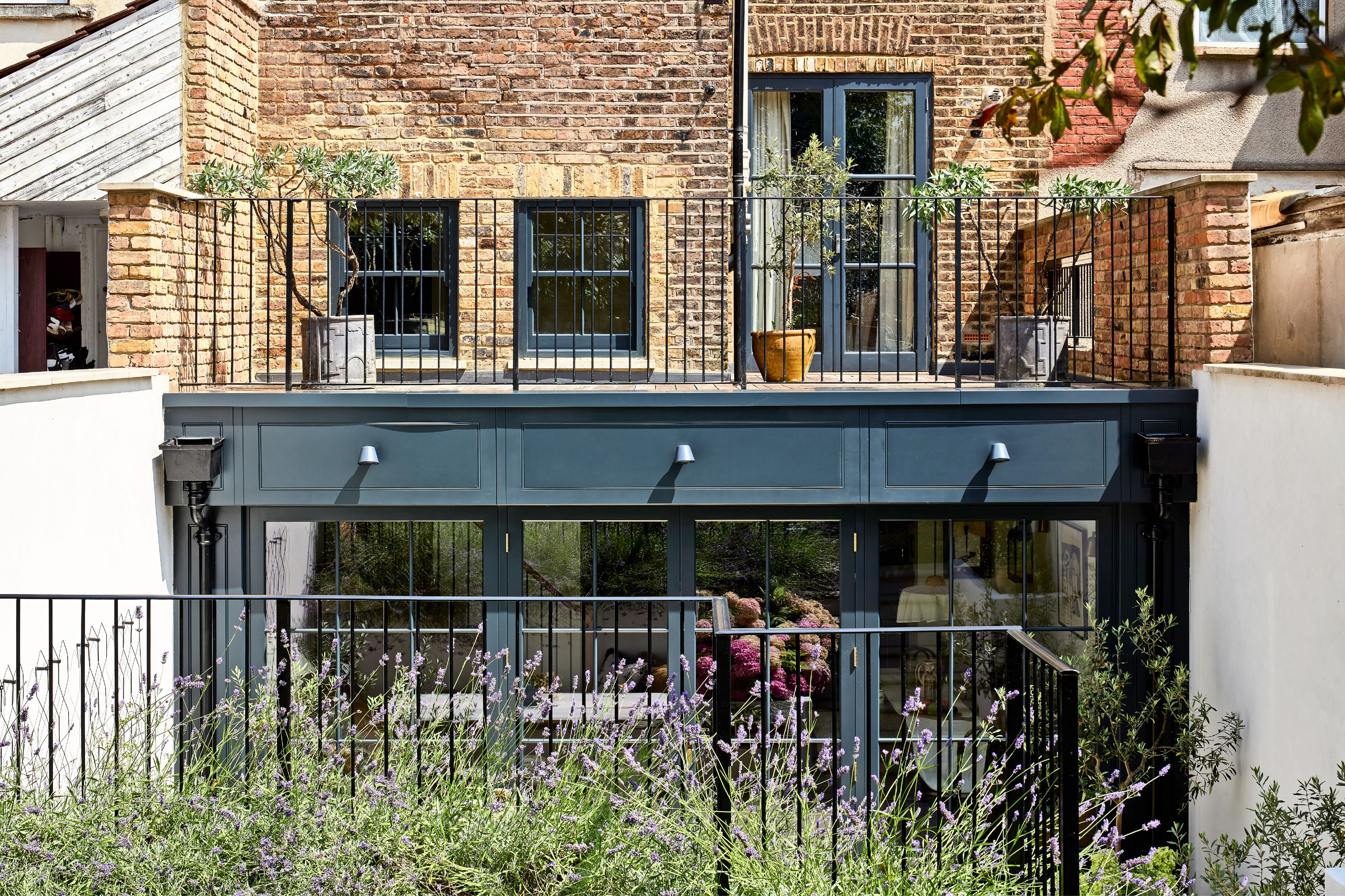 Balcony and garden room extension on a brick building.