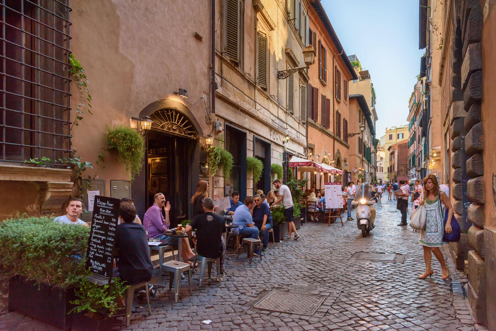 Cafés in the Trastevere district of Rome, with people dining outdoors.