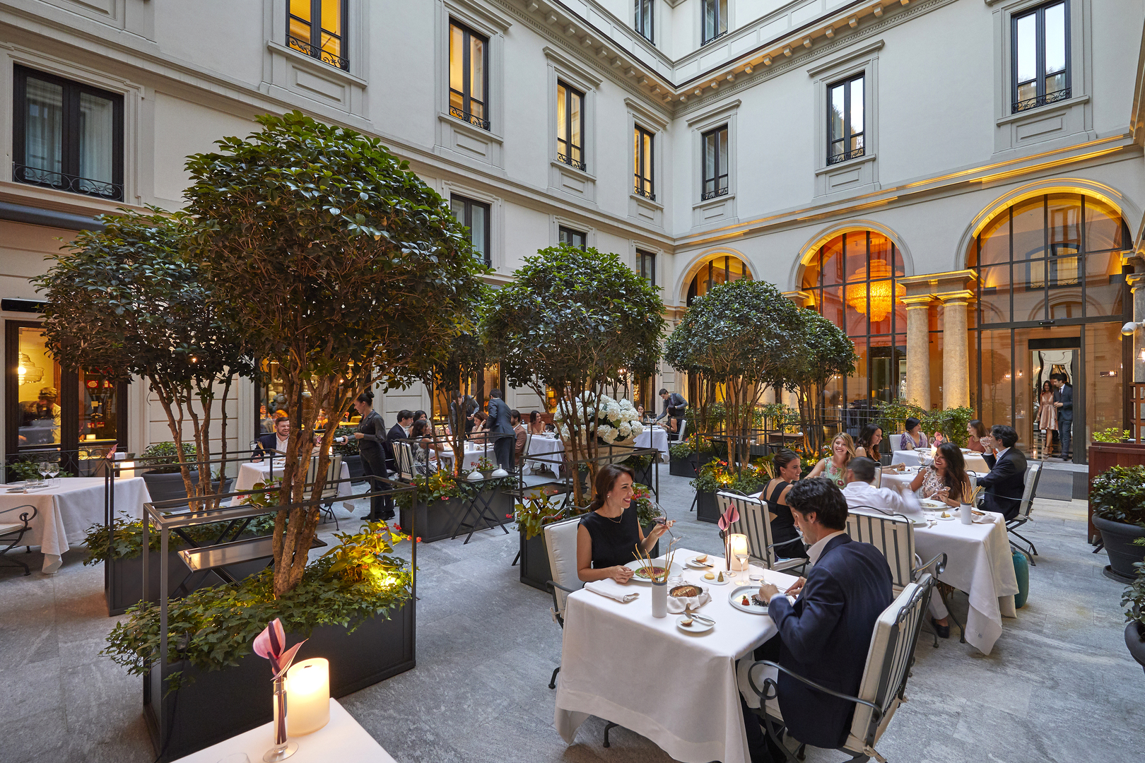 Diners in the courtyard at Seta restaurant in Milan