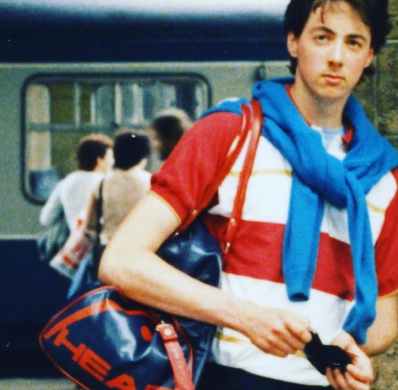 Julian Kynaston as a youth at a train station.